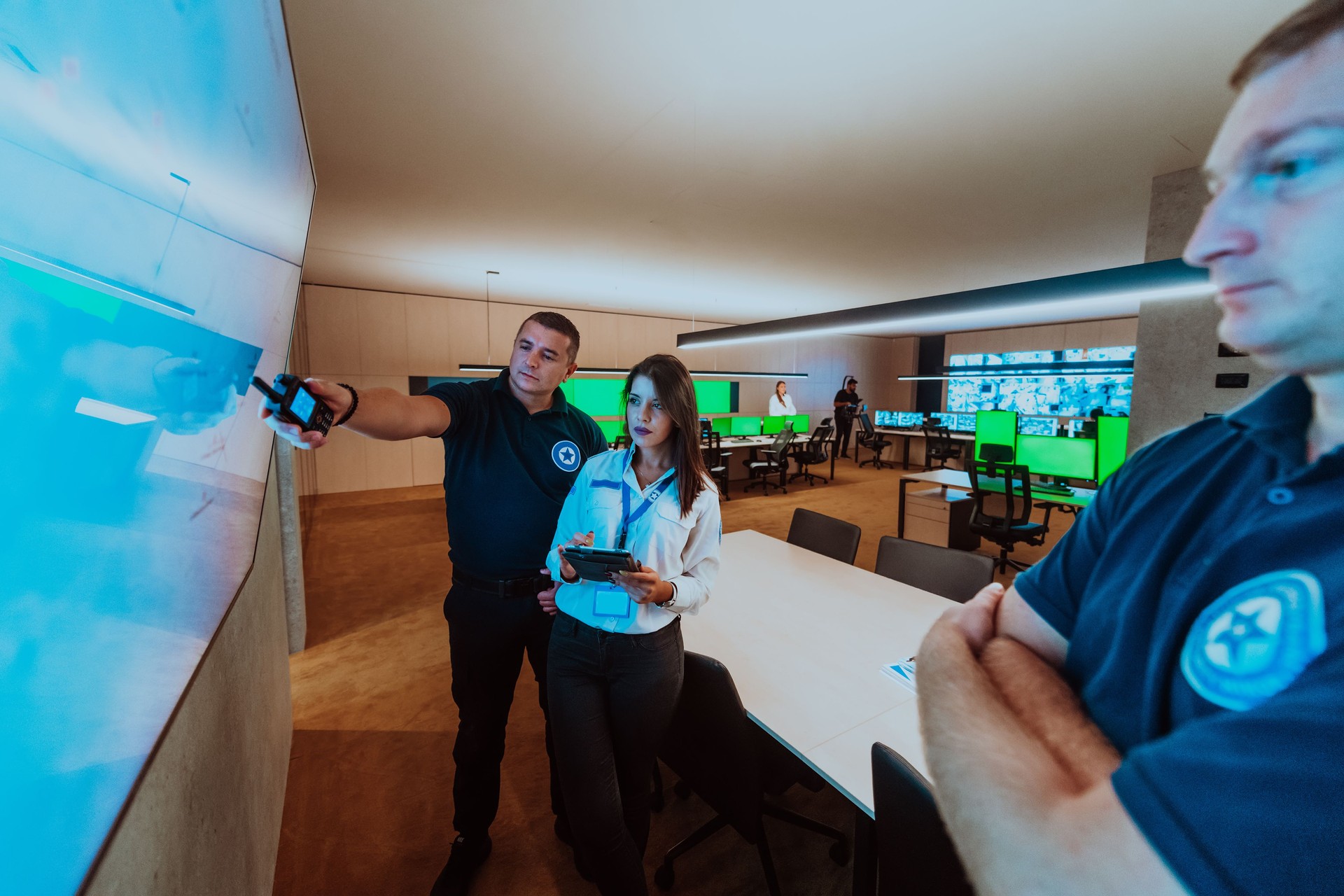 Group of security operators working in a data system control room Technical Operators Working at workstation with multiple displays, security guards working on multiple monitors in surveillan